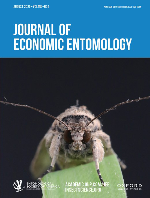 Journal of Economic Entomology cover, featuring white text on a blue background on top, with an image of a moth on a blade of grass below.